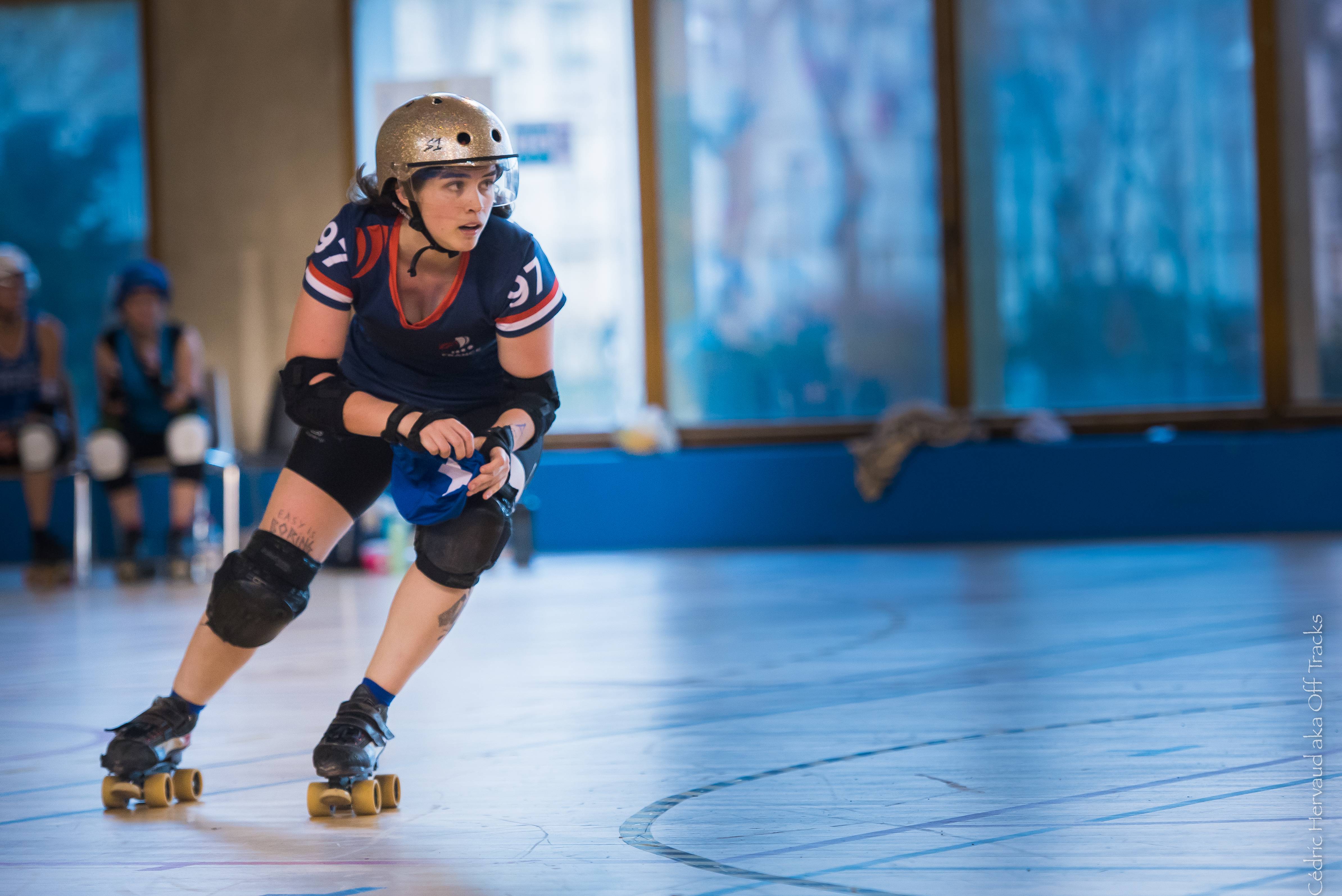 A roller derby player skating around the track