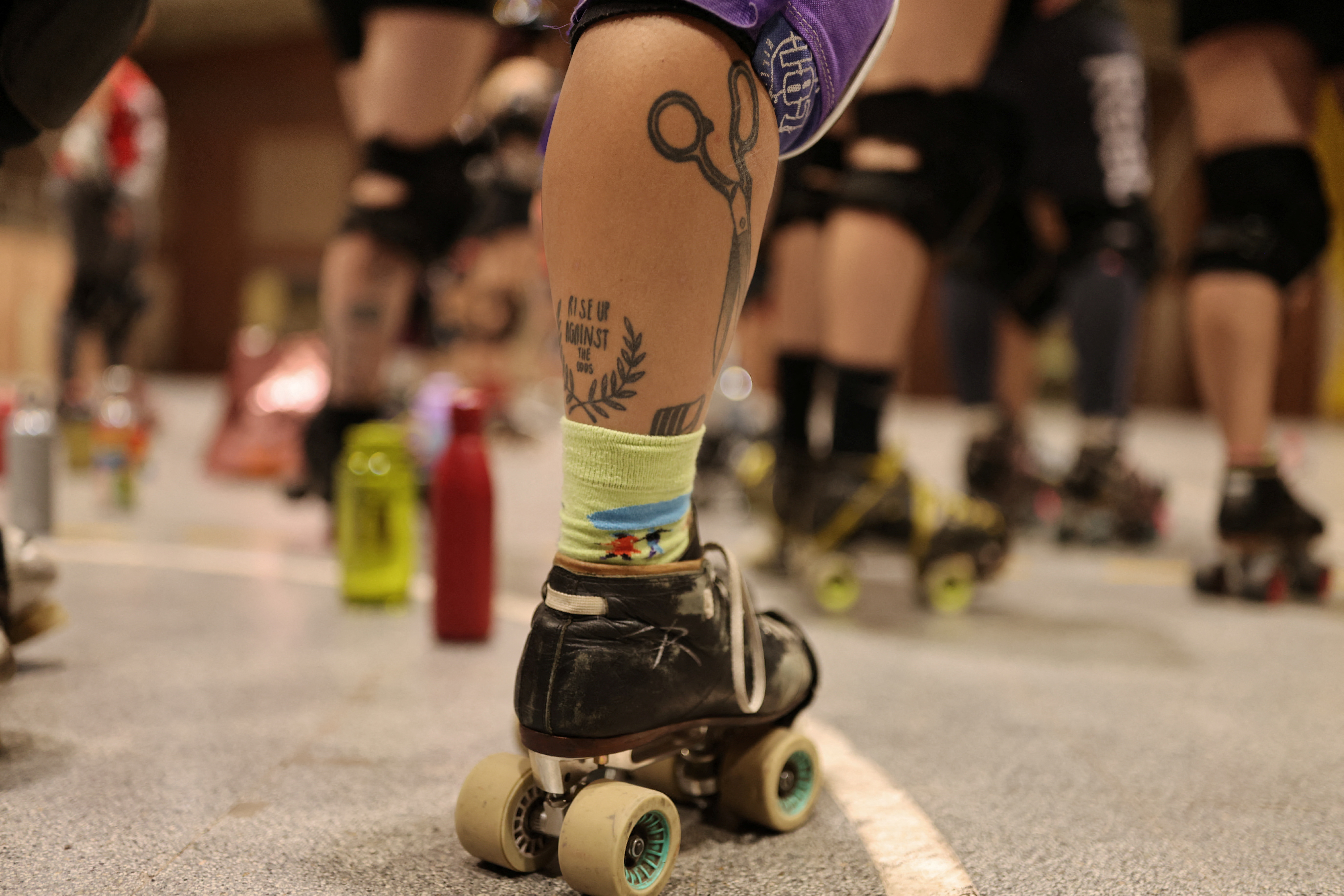 A roller derby player's leg, showing their skate