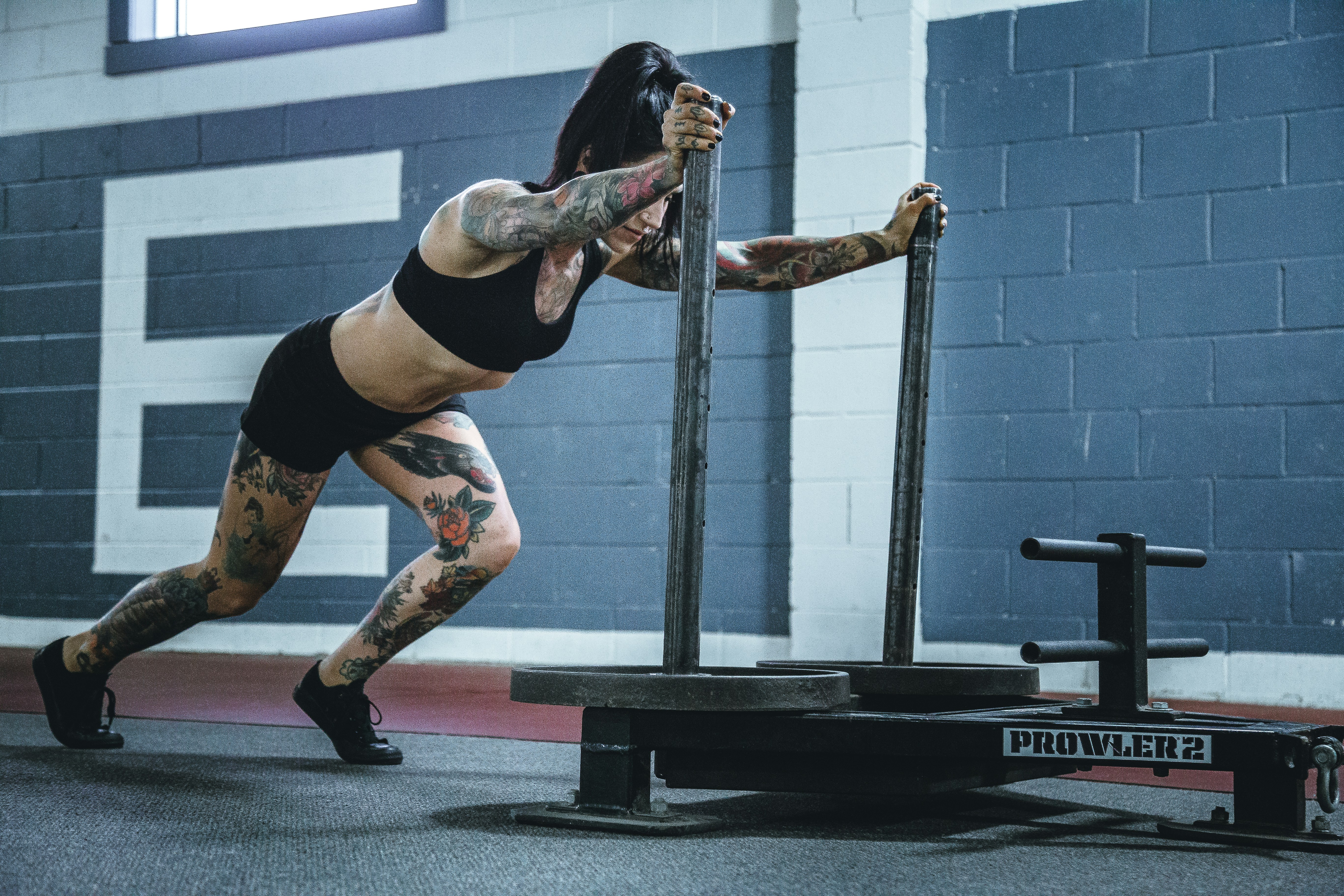 woman pushing a weighted sled
