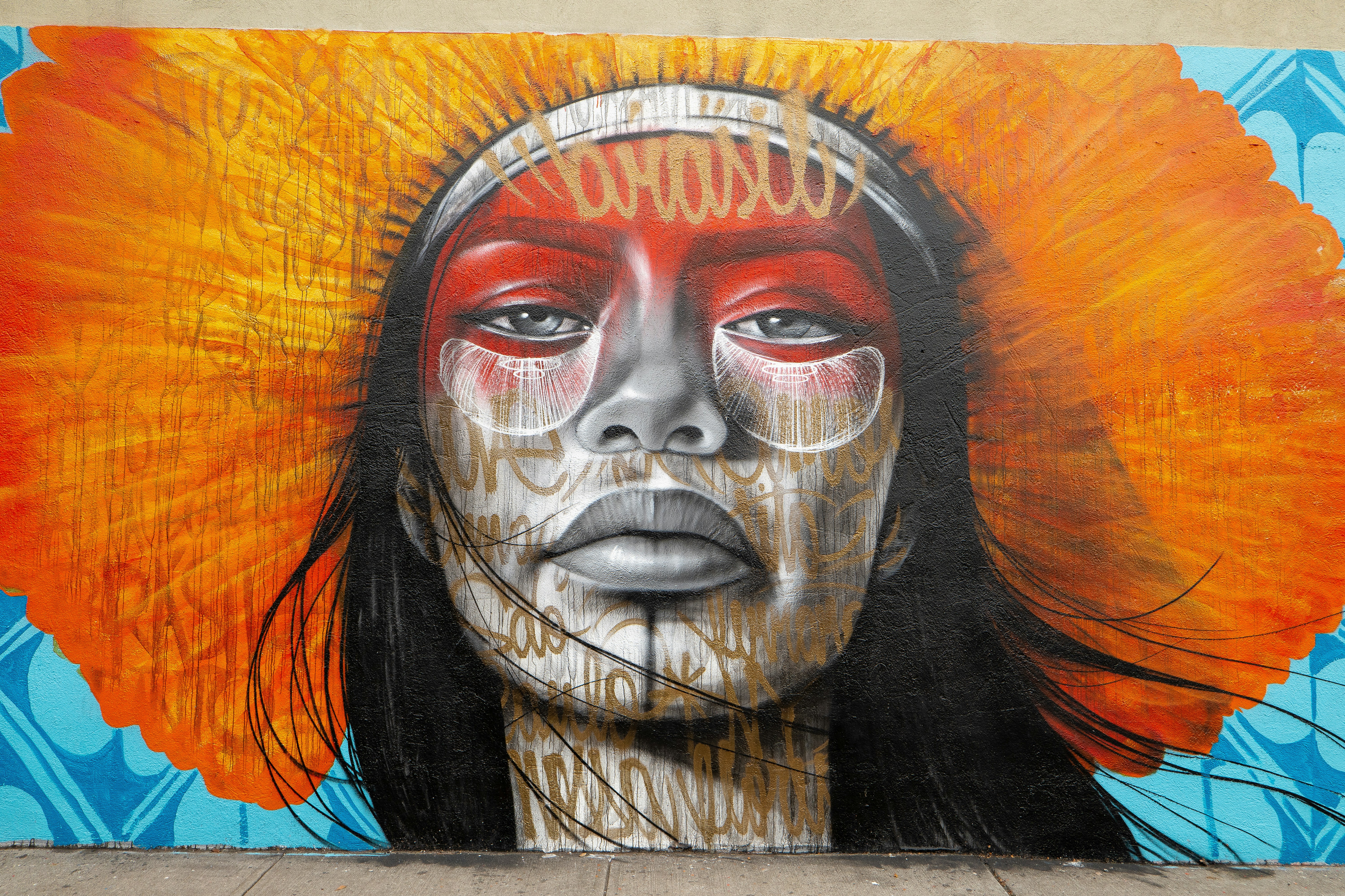 indigenous woman painting color blue orange
