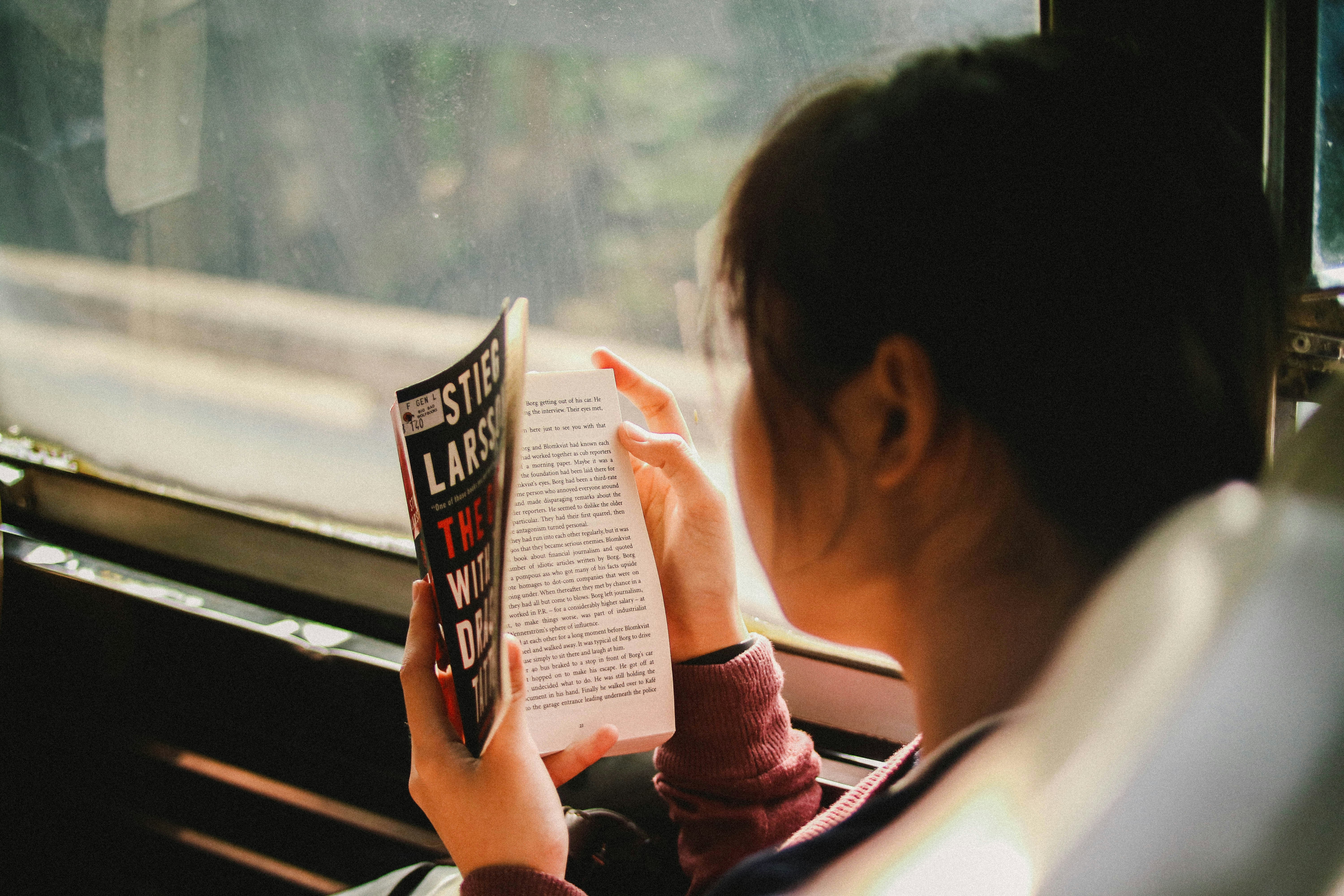 Girl reading in a bus
