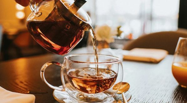 A tea cup filled with steeped loose-leaf tea