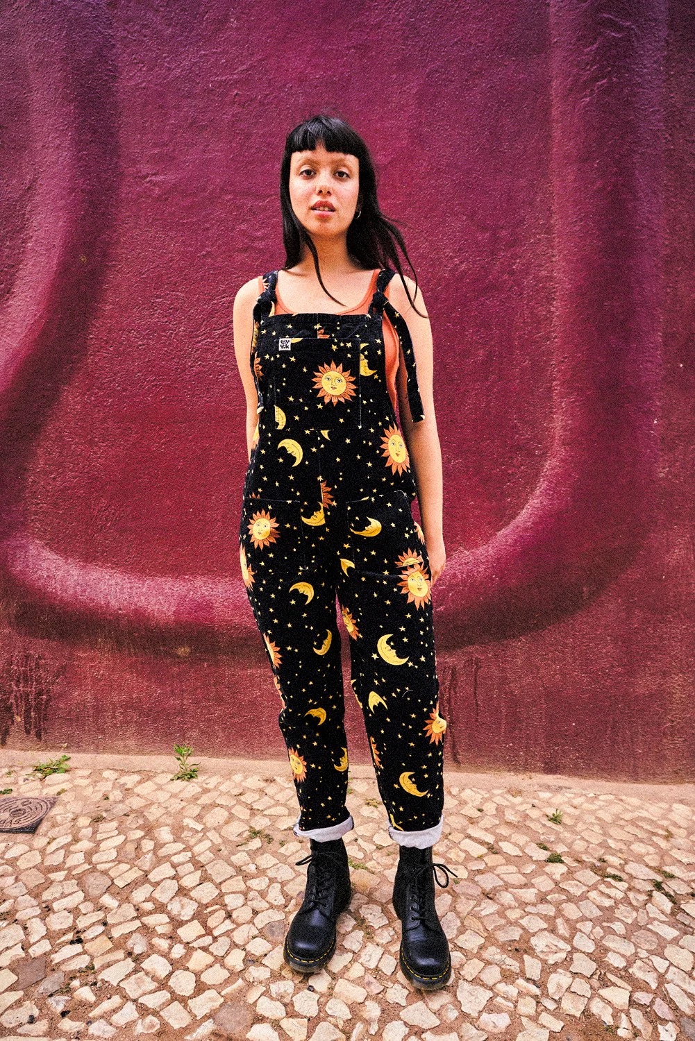 Women wearing Lucy and Yak Orion print dungarees