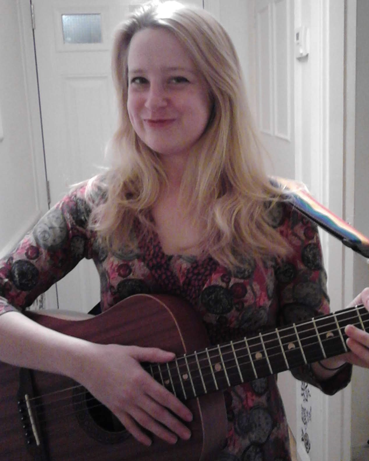 Happy girl playing guitar