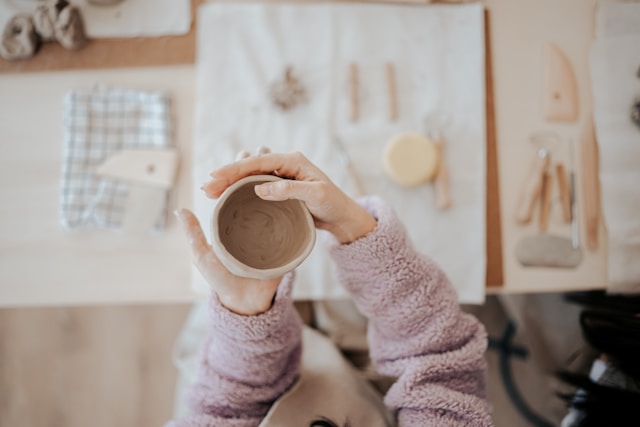 woman shaping pottery
