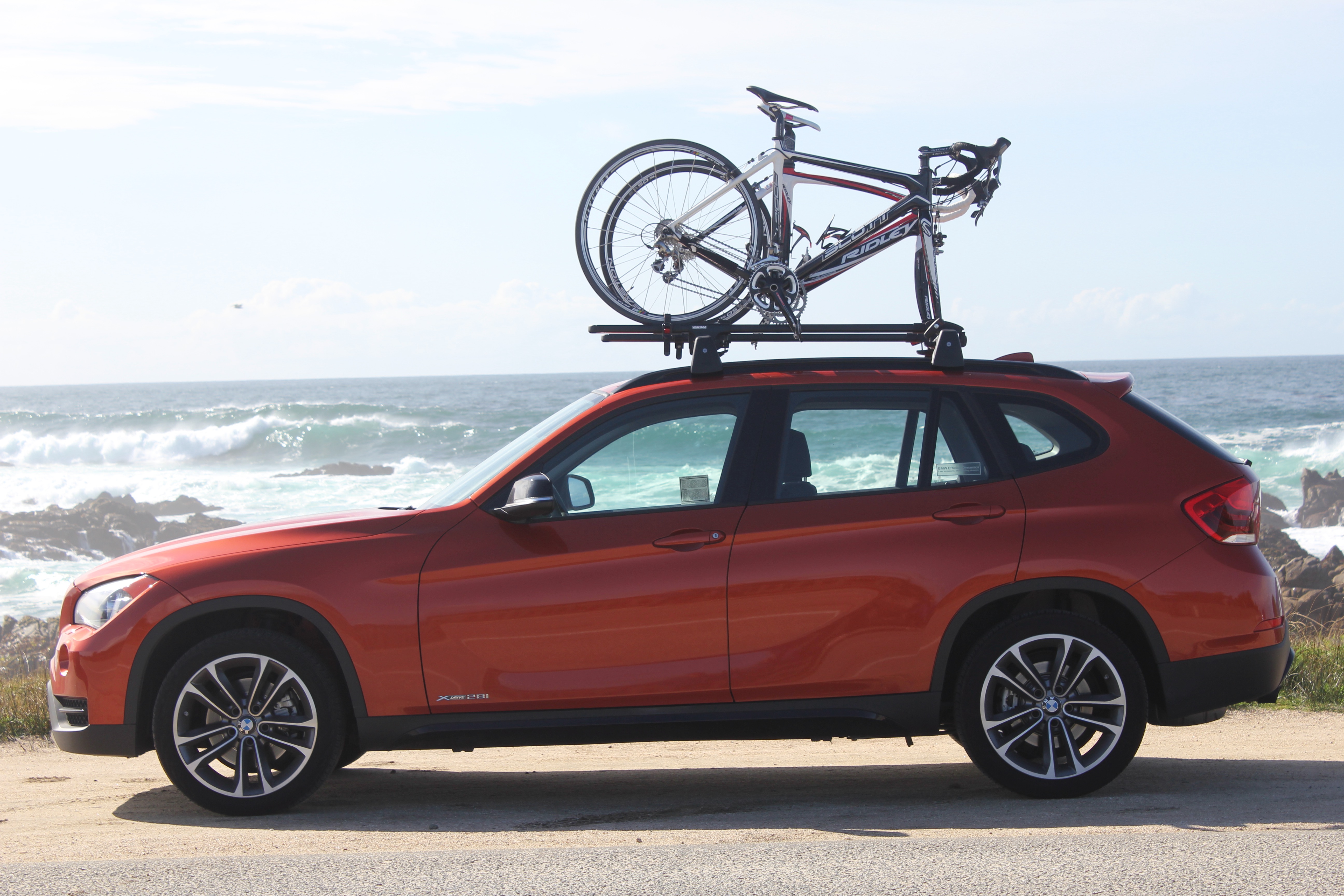 Bicycles on a car rack along a beach bike path