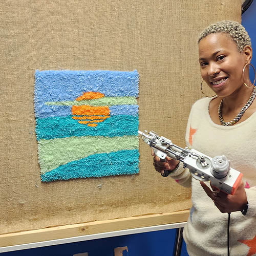 woman tufting a rug