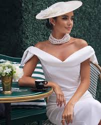 woman wearing all white, pearls and exuding confidence