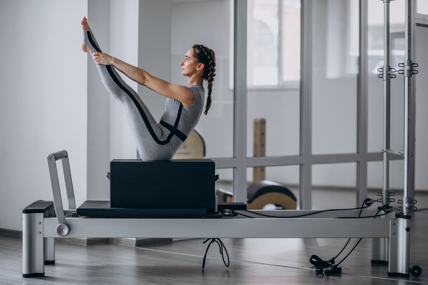 Woman balancing on Pilates Reformer