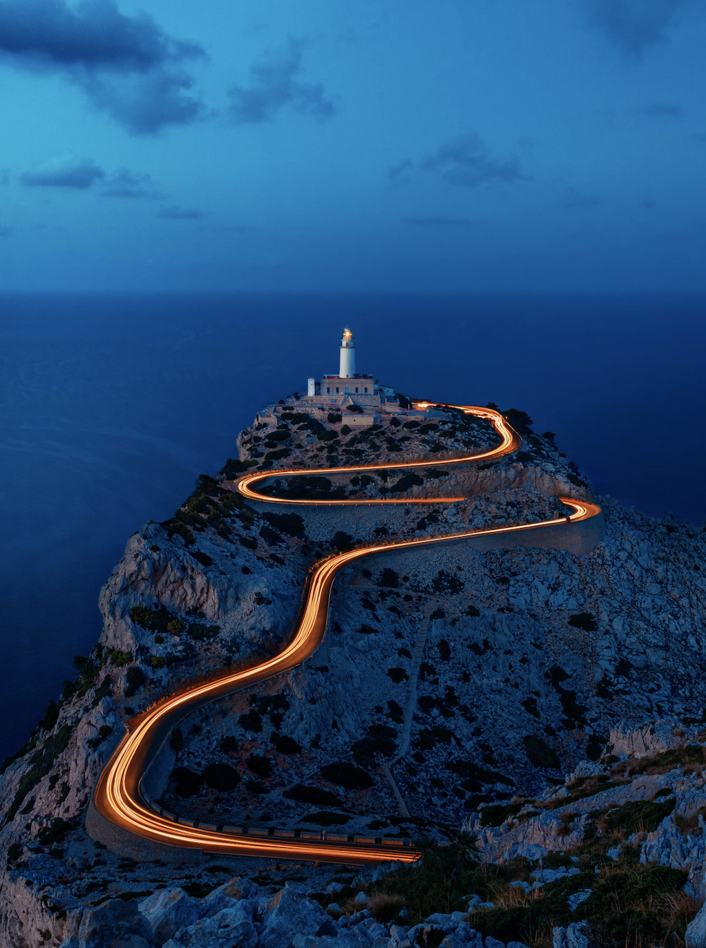 winding path leading to a lighthouse in Mallorca at night