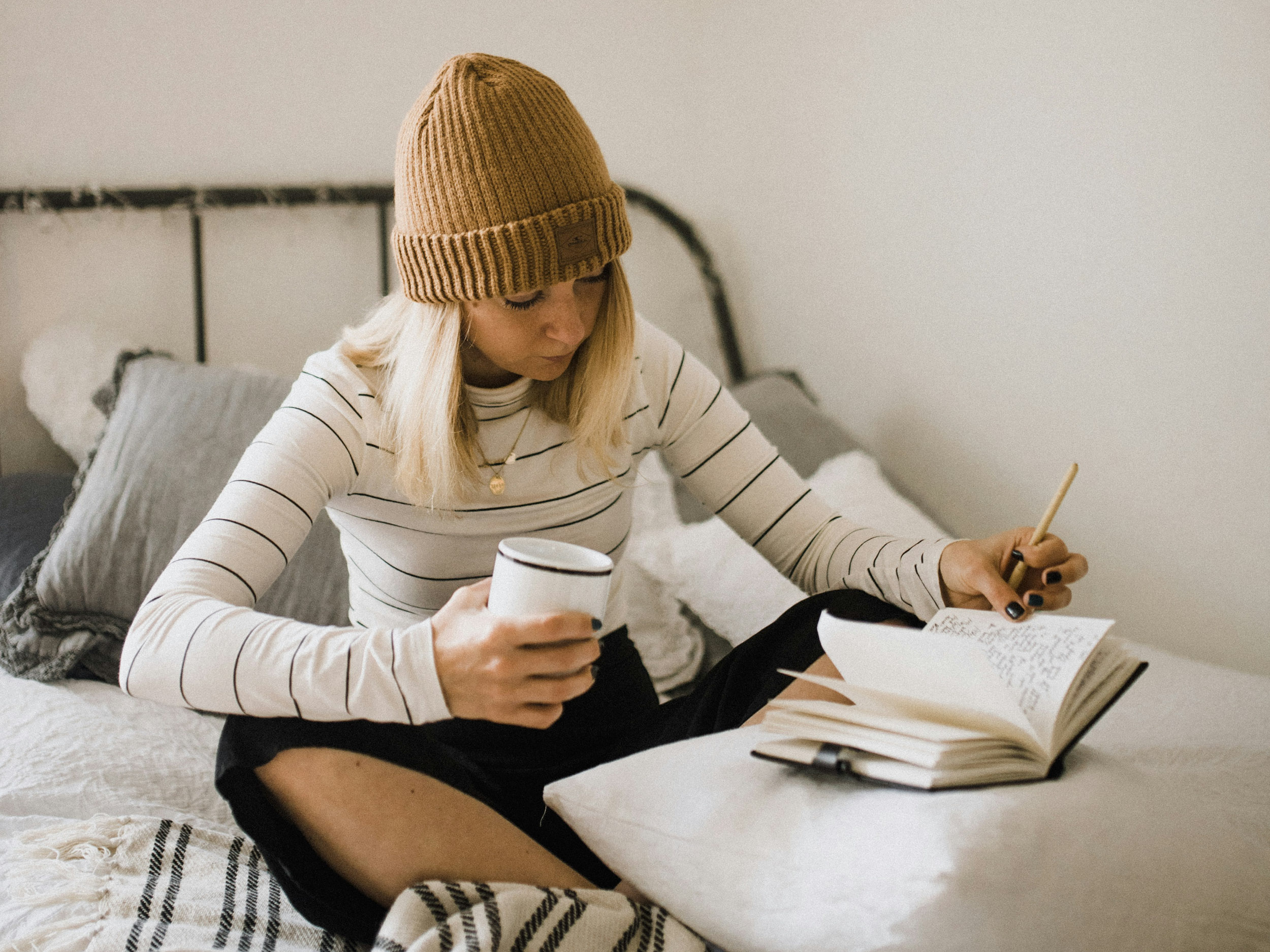 woman reading in bed with tea