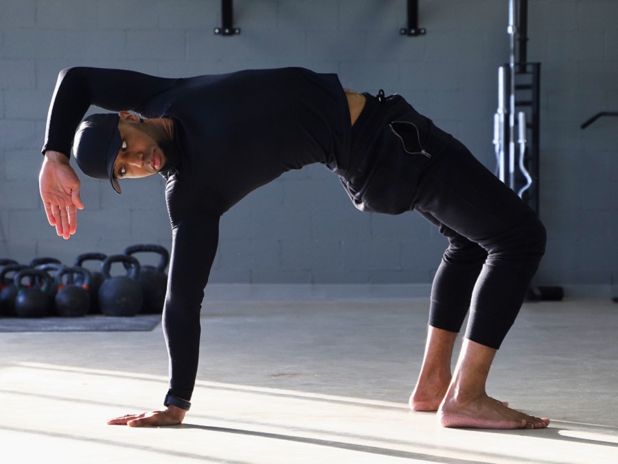 A man practicing Animal Flow movements during a workshop