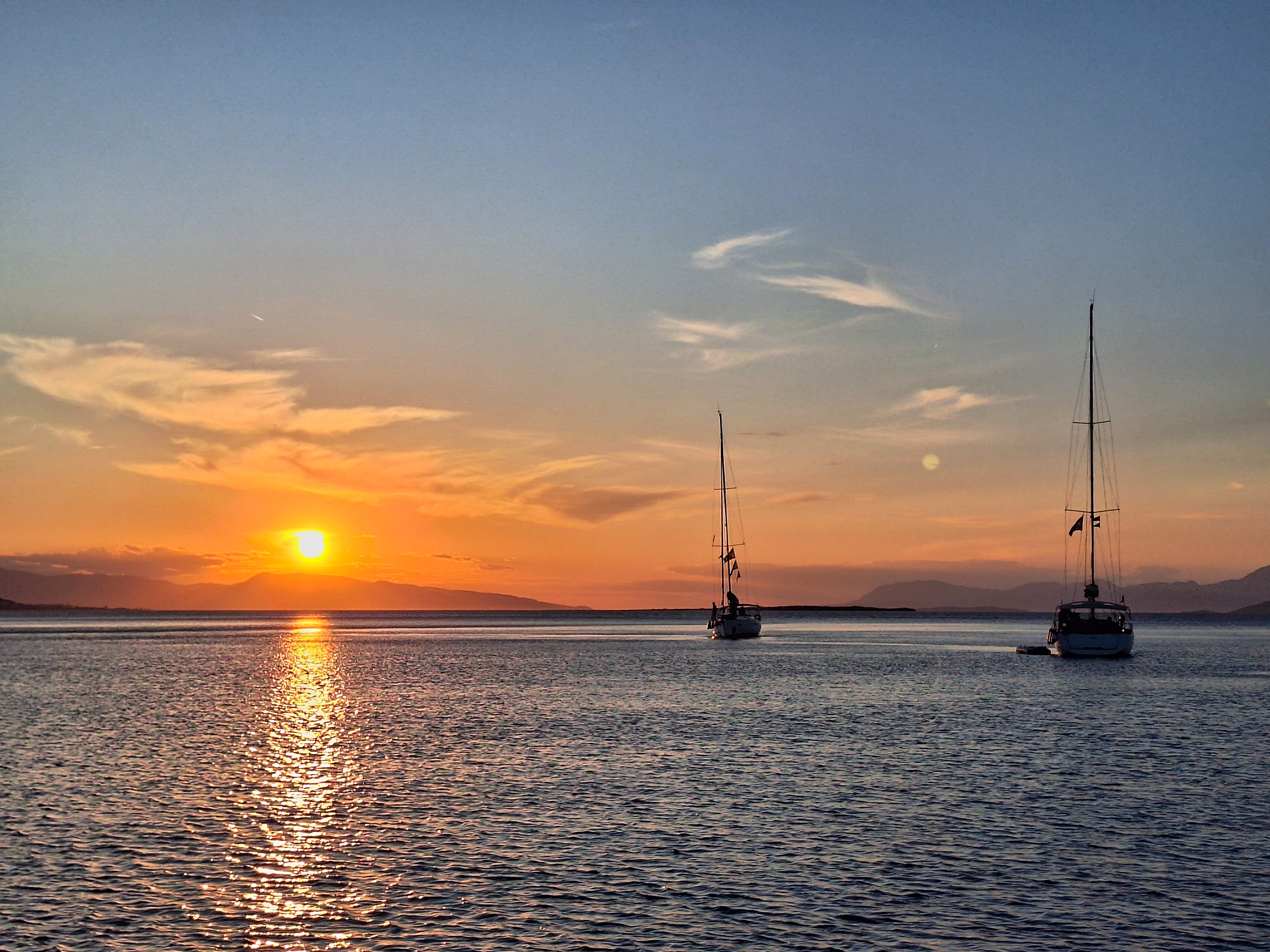Two sailing boats during sundown
