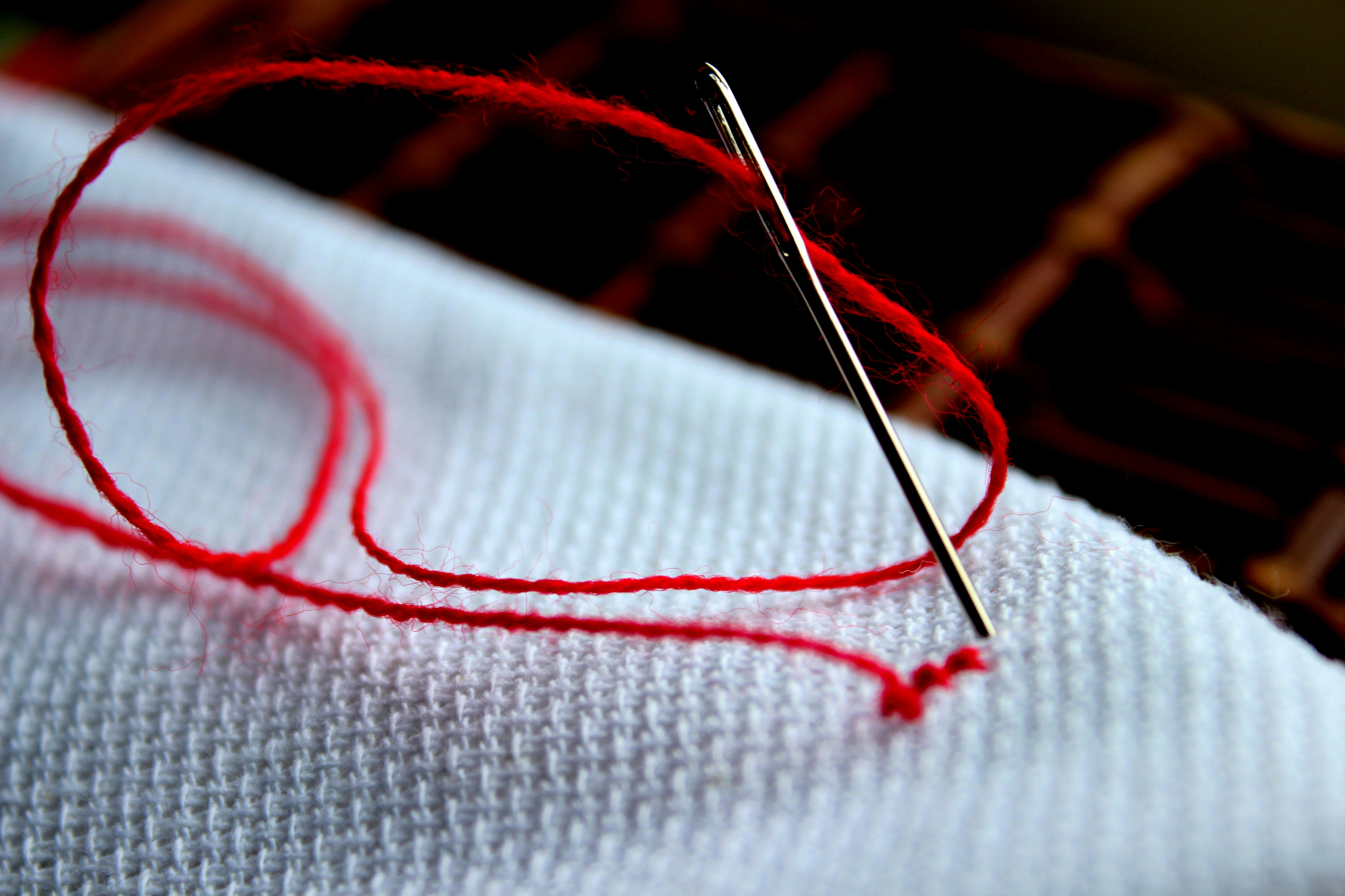 Close up of piece of cloth with a needle
