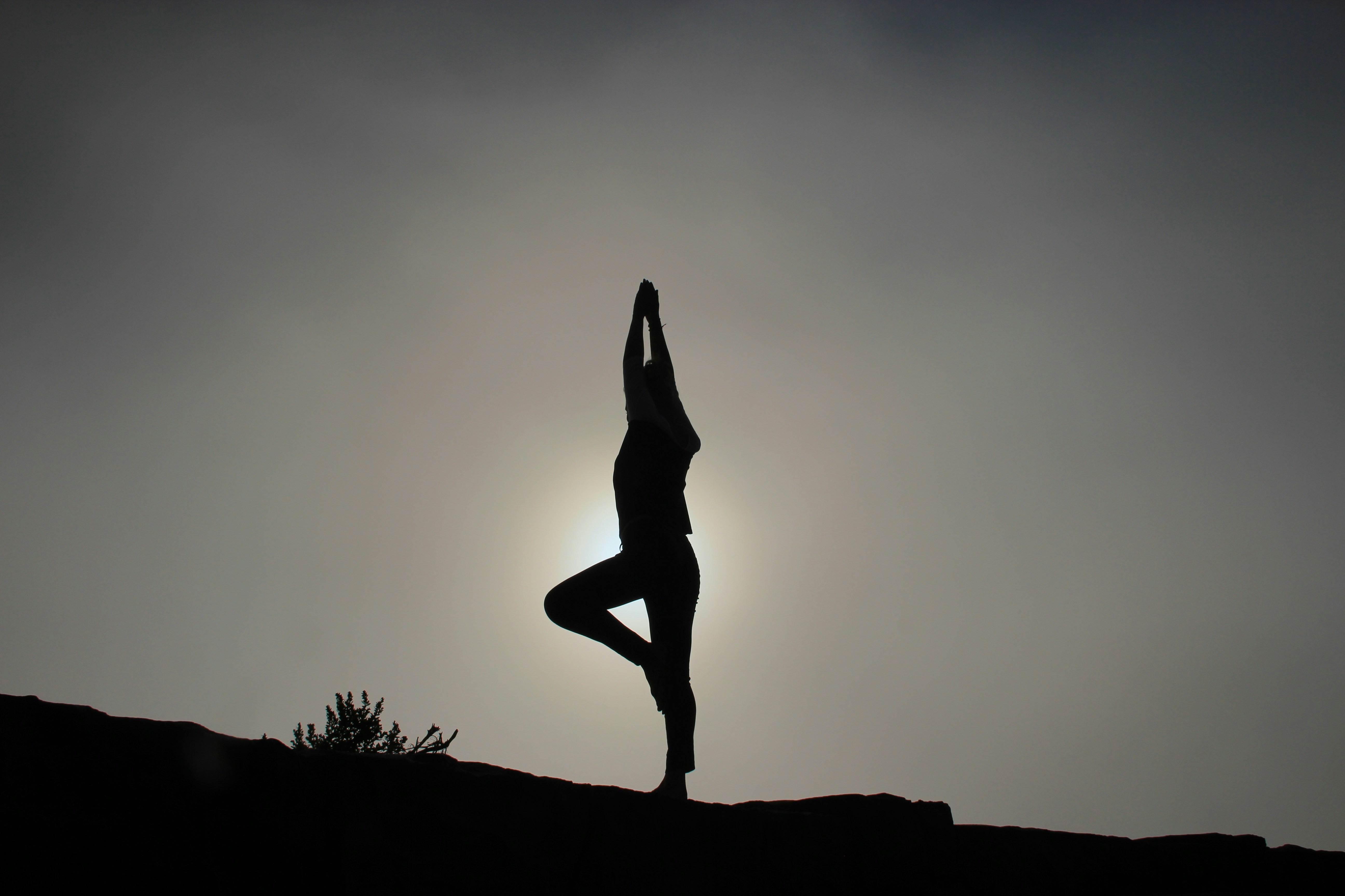 silhouette of woman doing a yoga pose