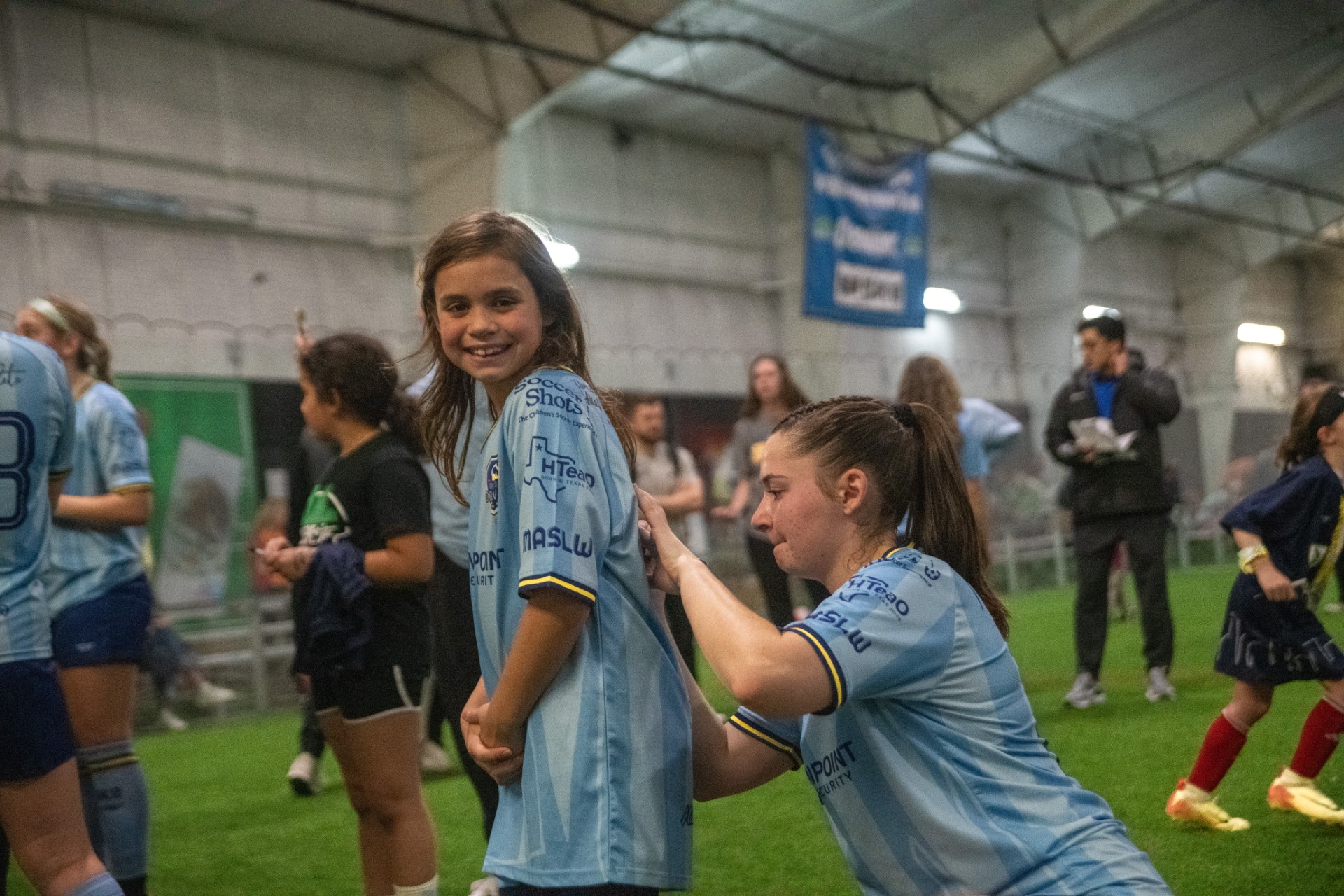 Player signing young fan's jersey.