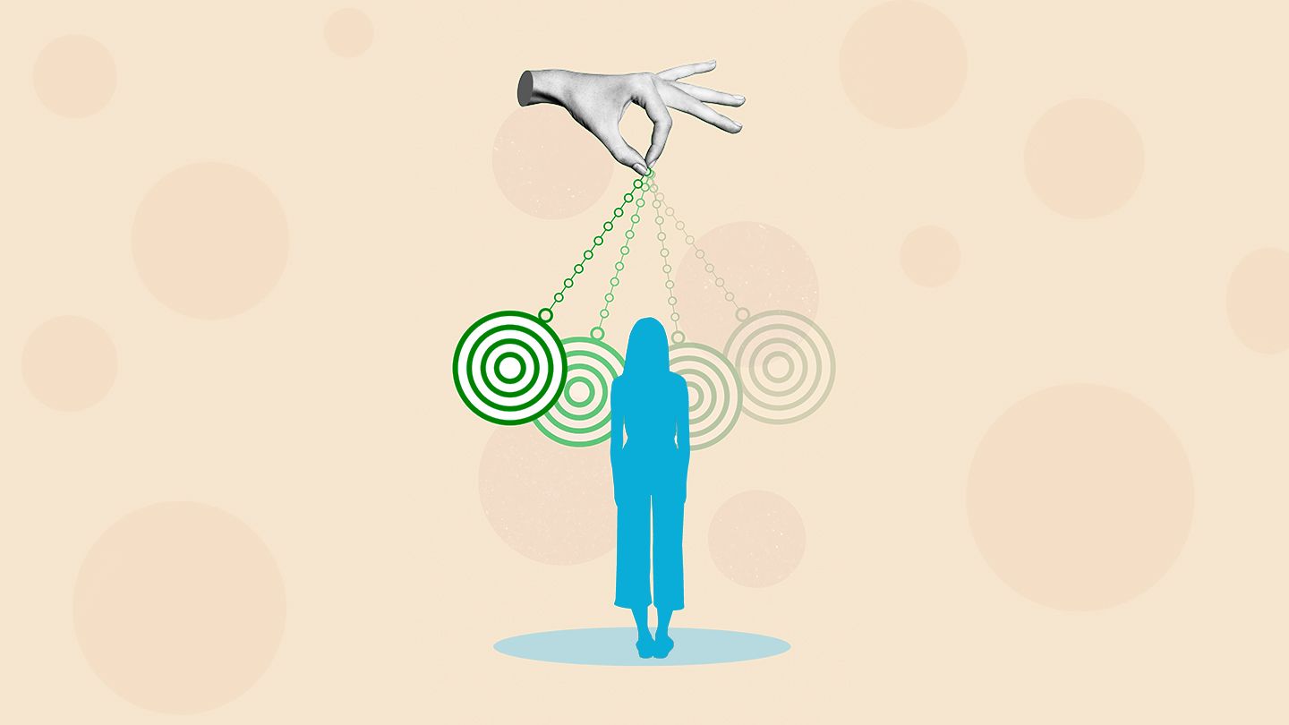 picture of hand dangling a watch in front of a female figure