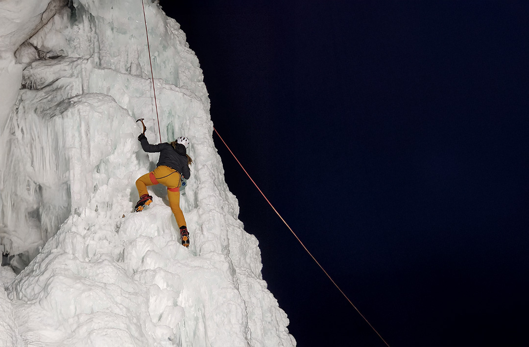 Woman ice climbing