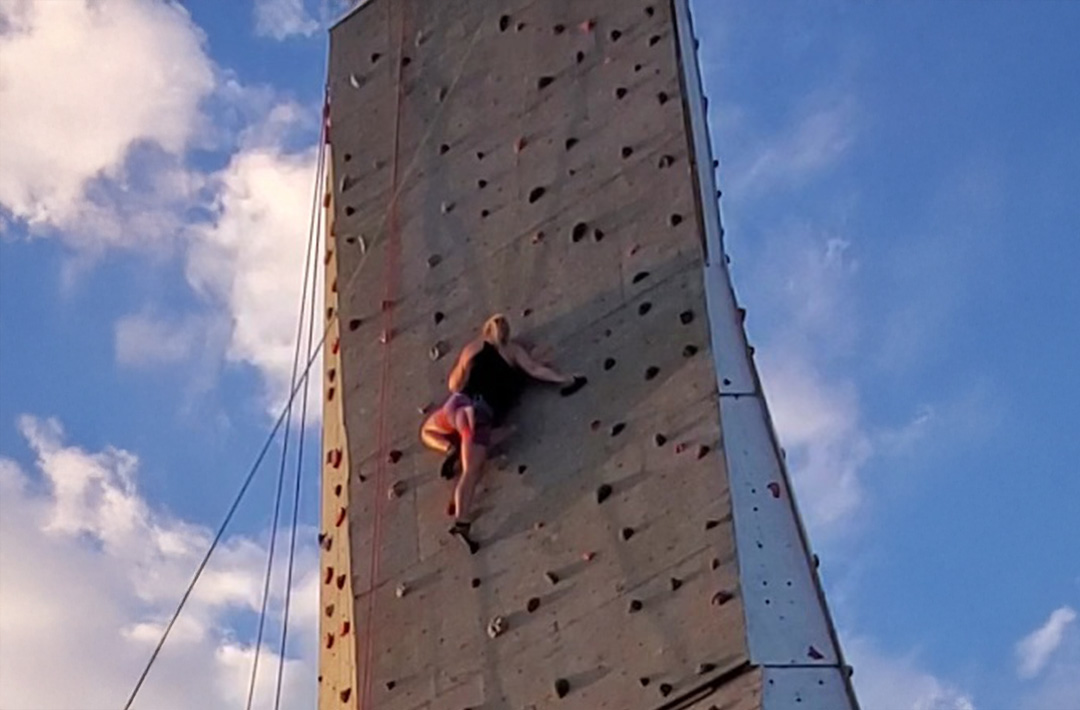 Woman top-rope climbing outdoors