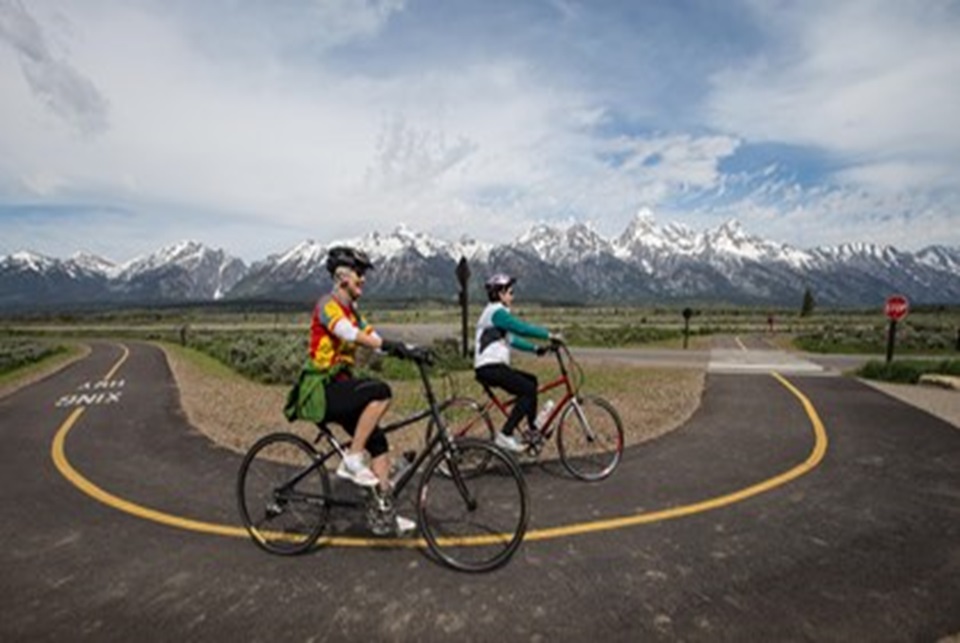 woman riding bikes on pavement