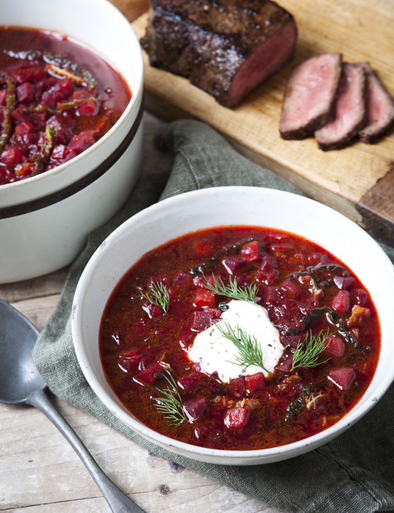 red soup in a bowl with a dollop of sour cream