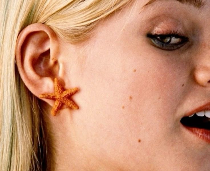 Aquamarine modelling orange starfish stud earrings