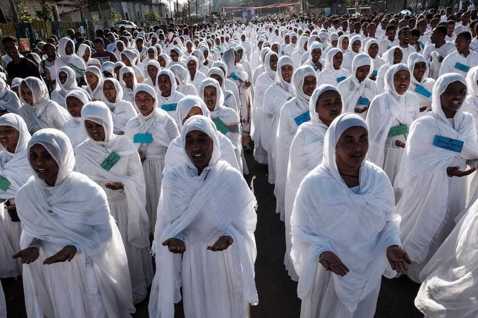 Timket ceremony at holy pool with worshippers in traditional clothing