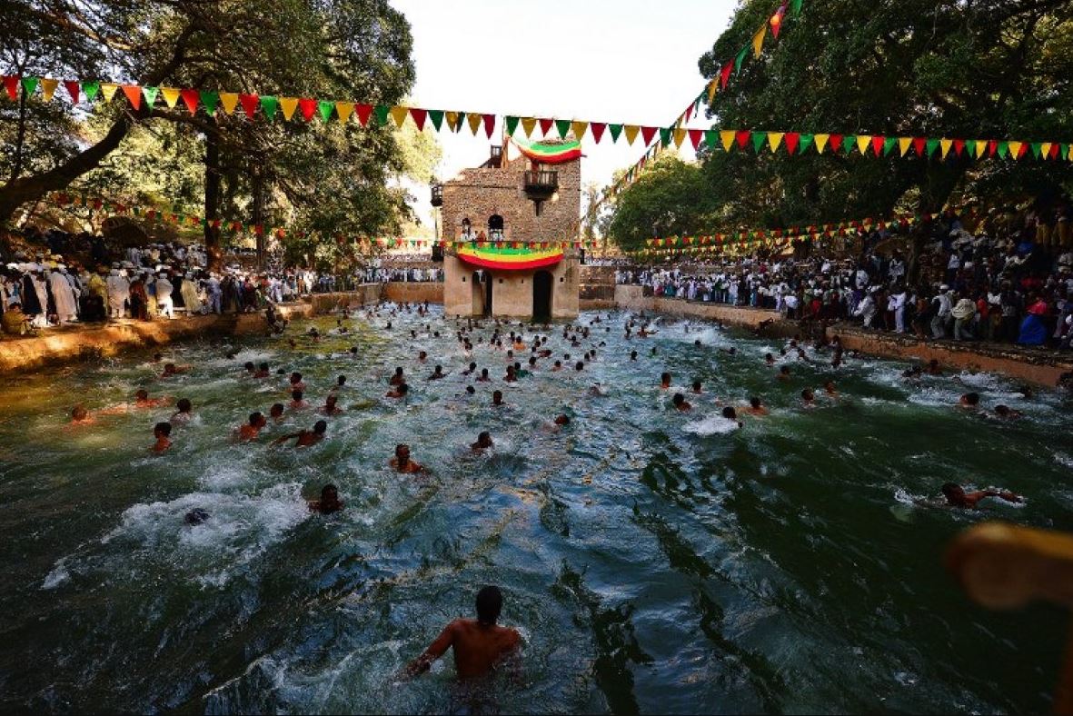 Participants swim in Fasilides’ Bath as part of Timket water blessing