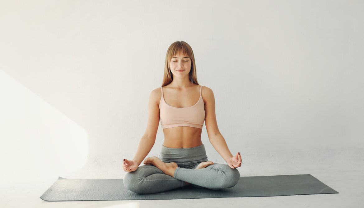 Woman meditating in Yoga class
