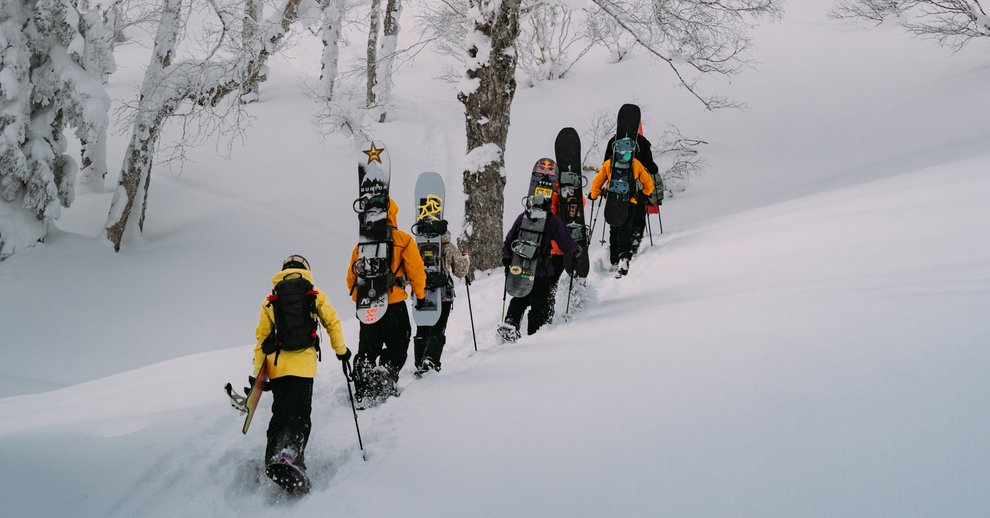 snowboarders walking up