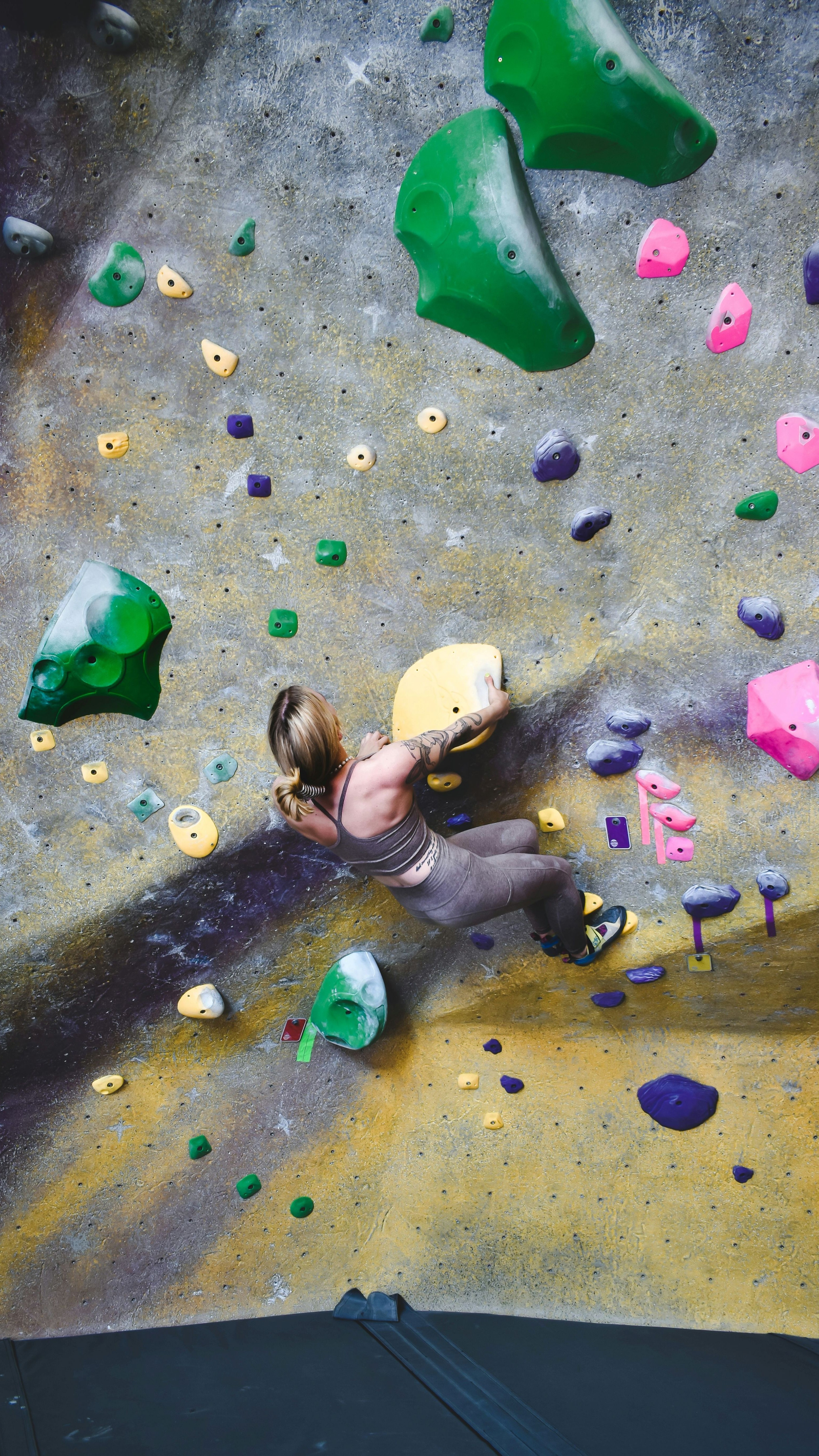Lady climbing an artificial rockwall