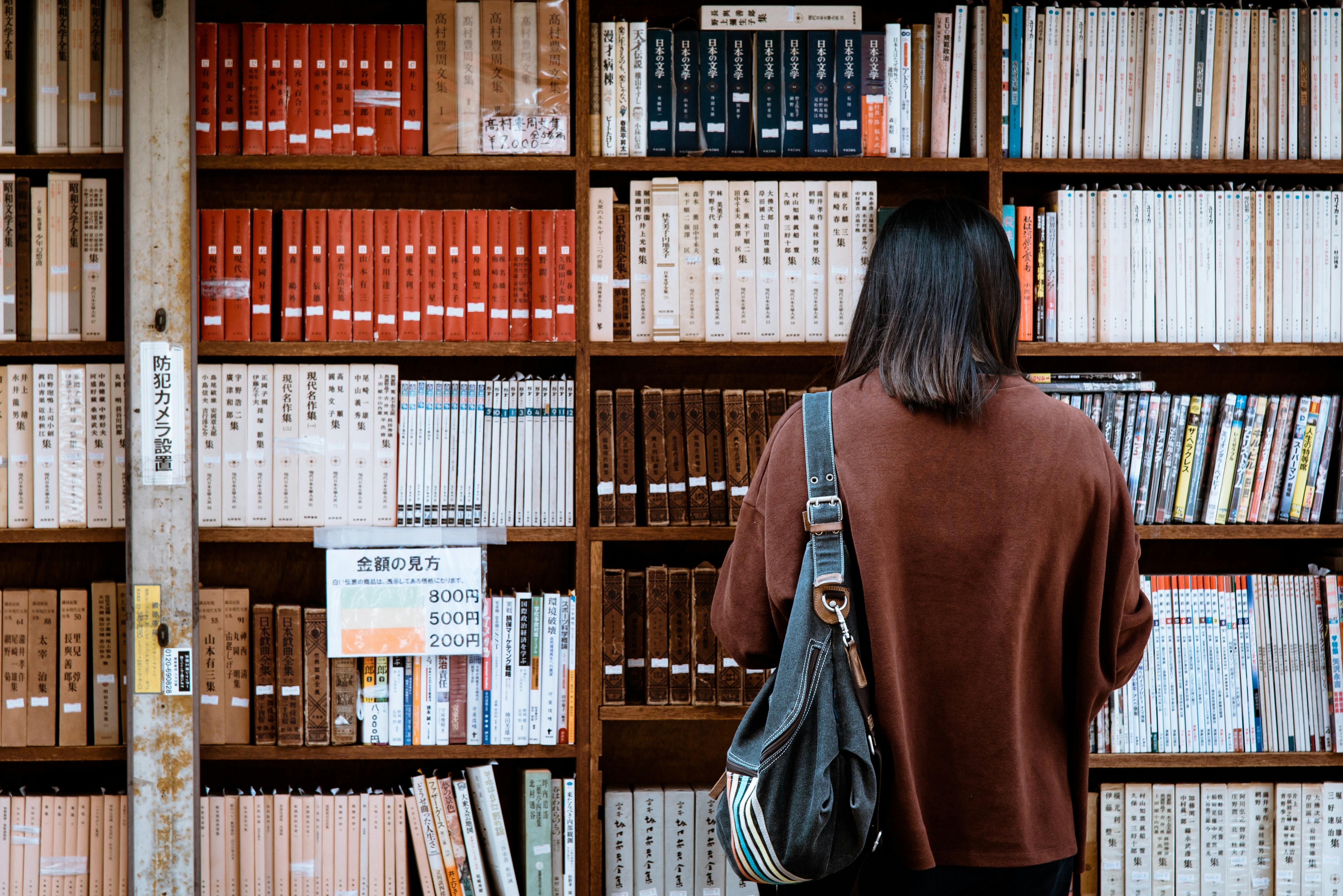 Girl around a boook shelf