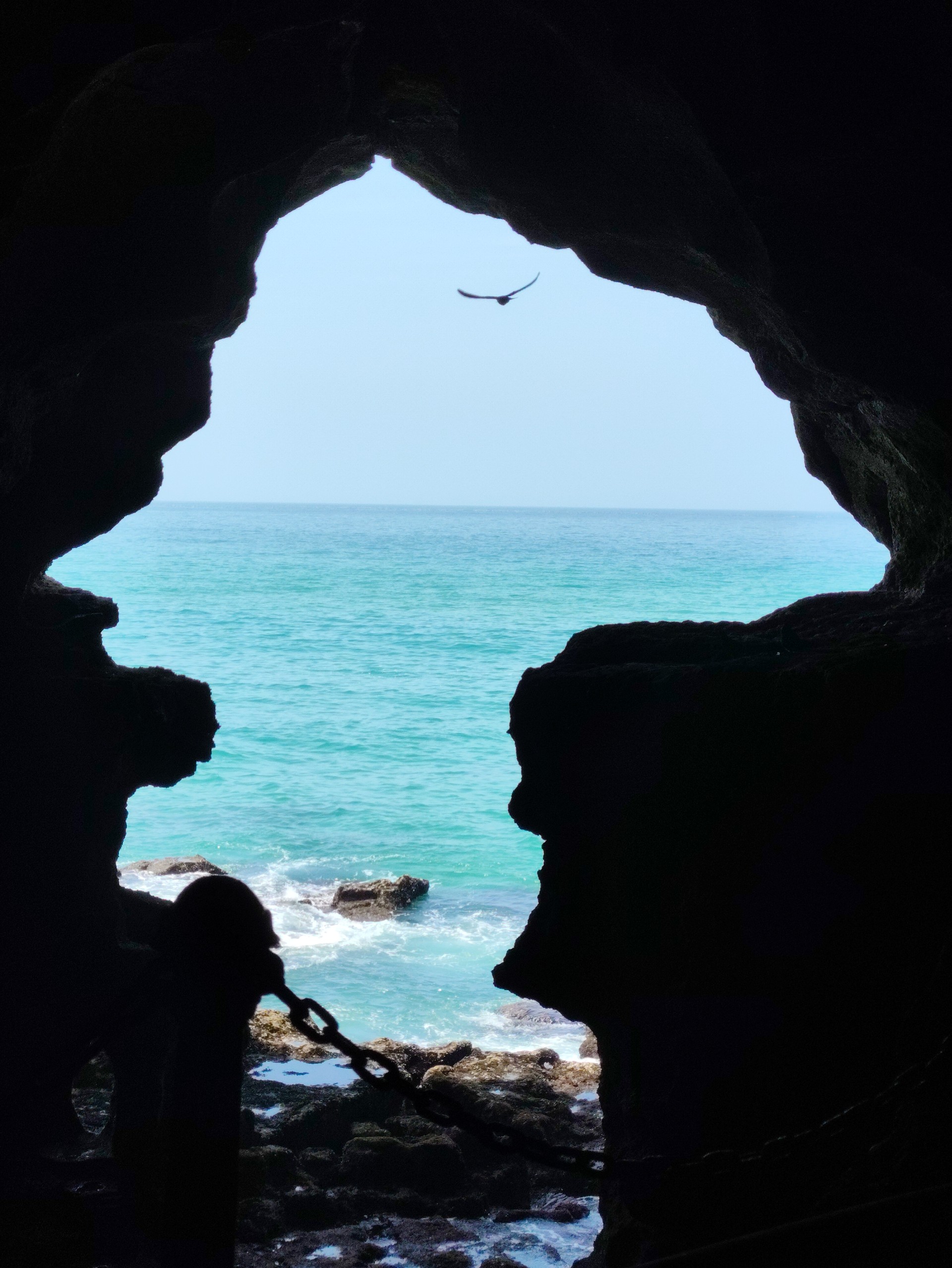 Sea view through the Africa-shaped opening at Grotte d'Hercule in Tangier
