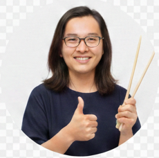 A happy female customer holding up chopsticks