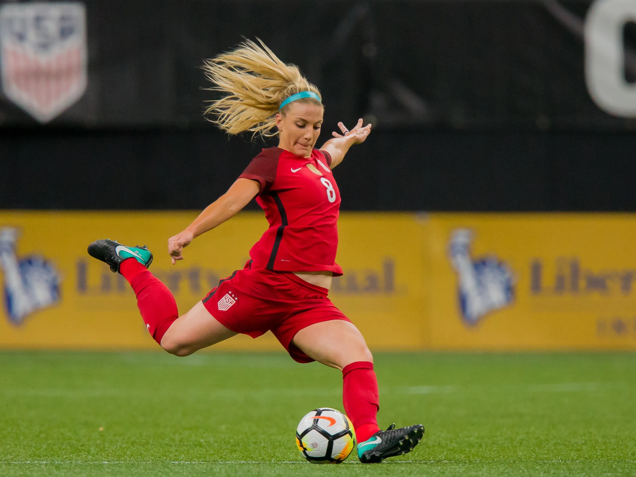 Julie Ertz kicking the ball