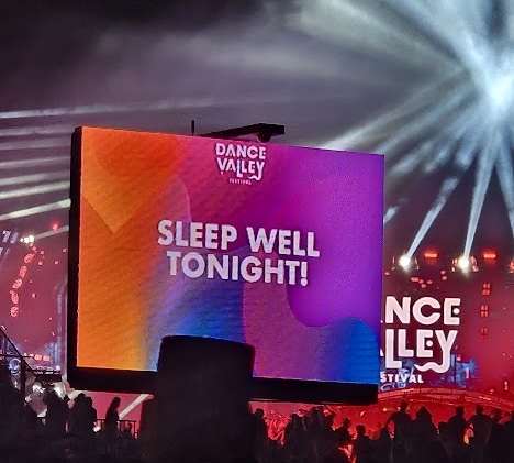 Message 'Sleep well tonight' in a festival environment