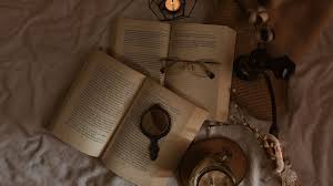 Two open books and a pair of glasses
