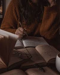 woman with a pencil in hand writing on paper