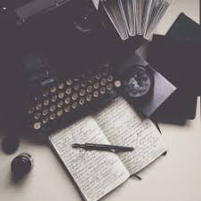 A written in notebook and a typewriter