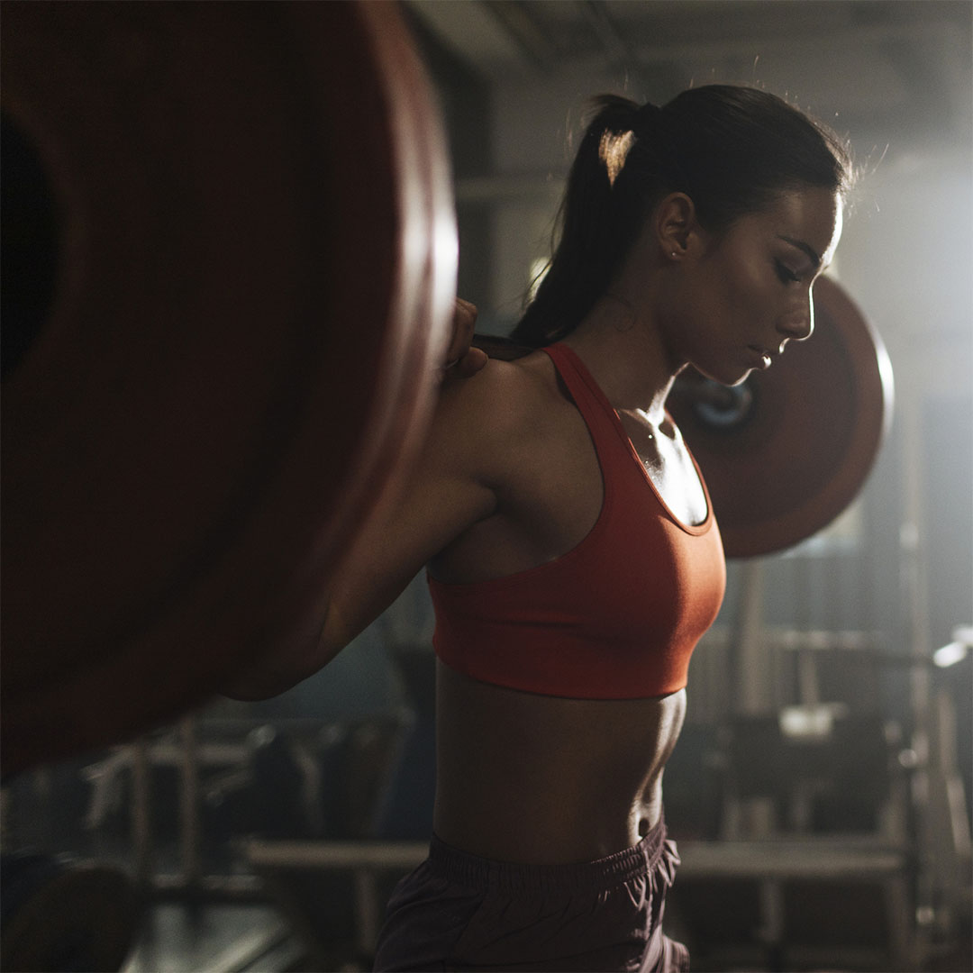 Woman doing a barbell back squat