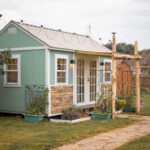 10x16 shed home office exterior with landscaping and awning