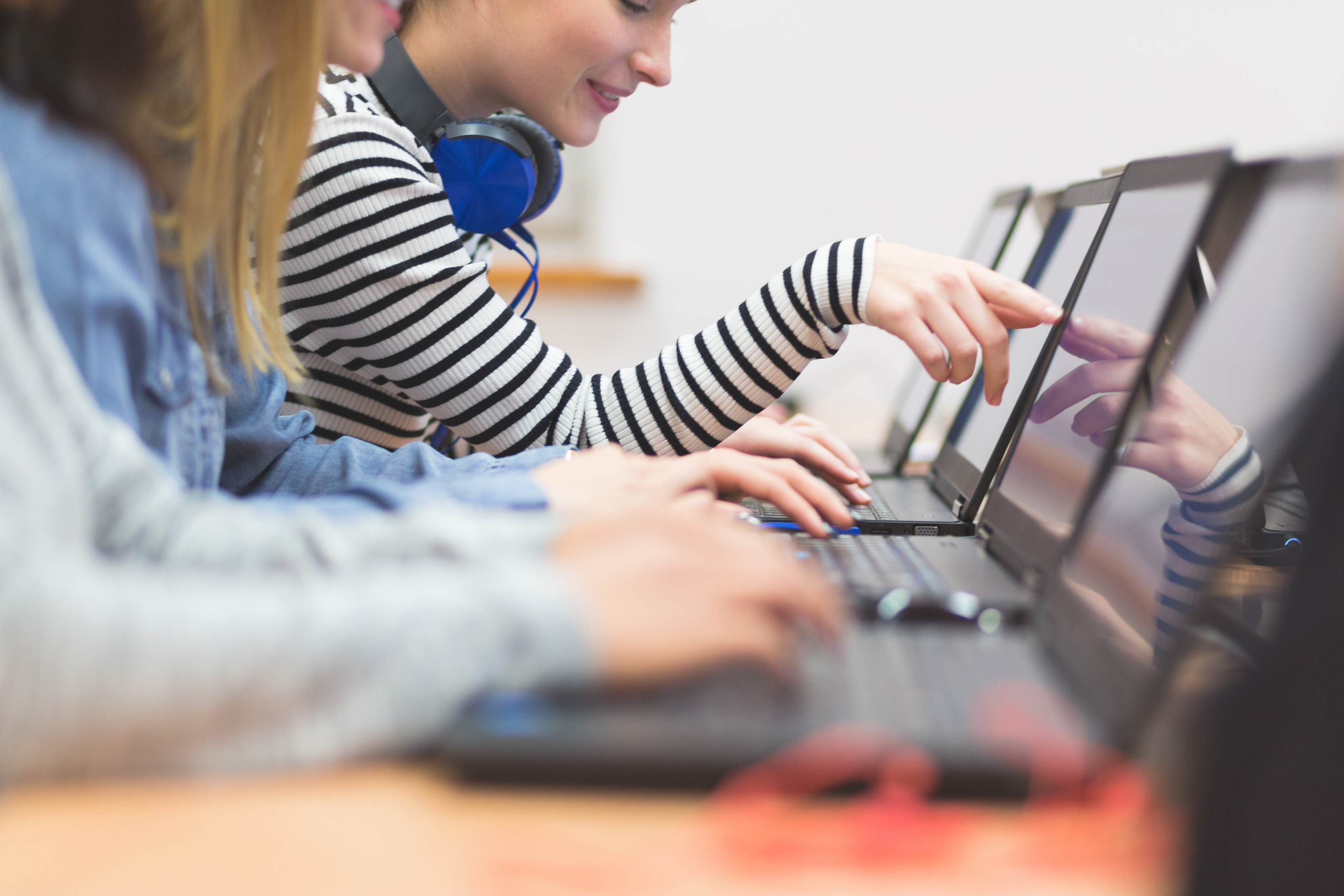 photo: computer in a girl's lap; converse shoes