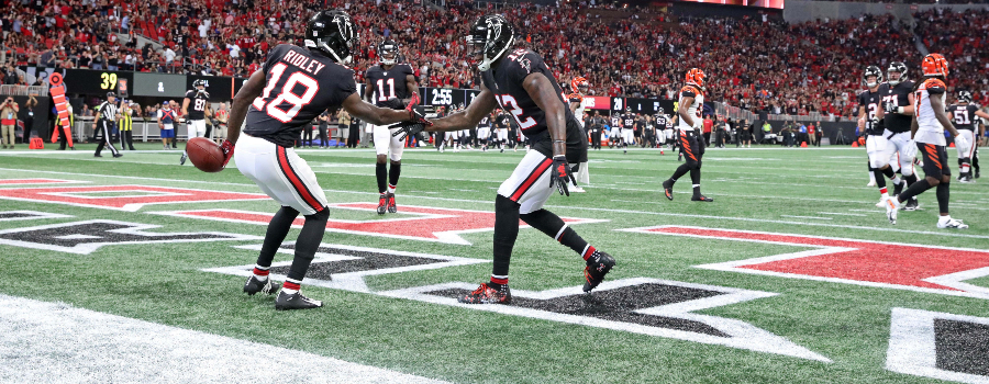 Atlanta Falcons wide receiver Calvin Ridley (18) celebrates with wide receiver Mohamed Sanu (12) after a catching a pass for a touchdown against the Cincinnati Bengals in the second quarter at Mercedes-Benz Stadium.