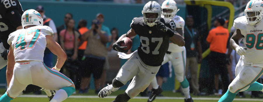 Oakland Raiders tight end Jared Cook (87) is pursued by Miami Dolphins linebacker Kiko Alonso (47) and defensive tackle Vincent Taylor (96) in the second quarter at Hard Rock Stadium.