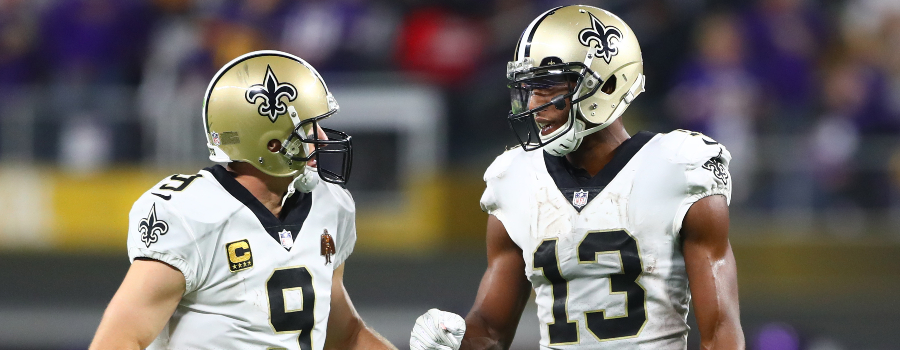 New Orleans Saints quarterback Drew Brees (9) talks with wide receiver Michael Thomas (13) against the Minnesota Vikings at U.S. Bank Stadium.