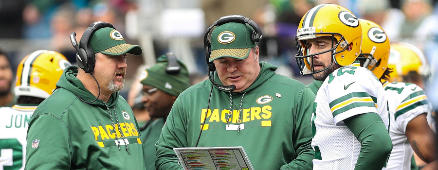 Green Bay Packers head coach Mike McCarthy talks withGreen Bay Packers quarterback Aaron Rodgers (12) during a timeout against the Carolina Panthers during the second quarter at Bank of America Stadium. 