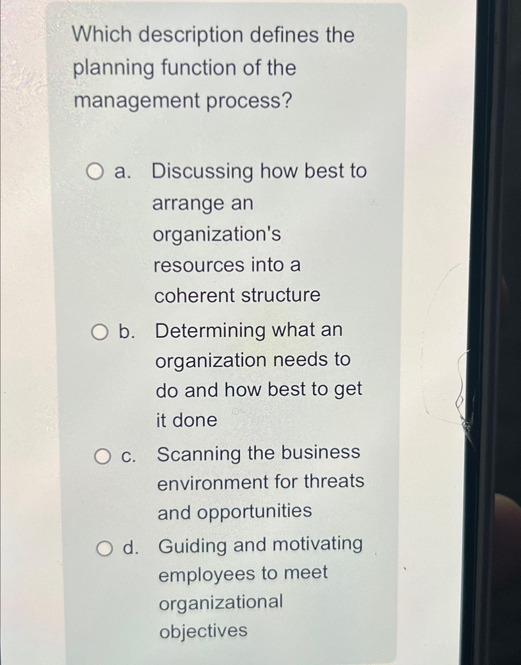 Which description defines the planning function of the management process? O a.