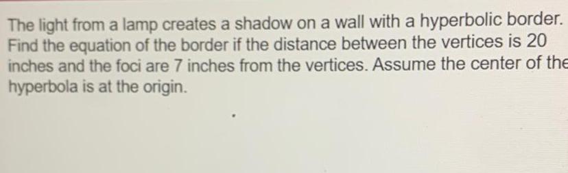 The light from a lamp creates a shadow on a wall with