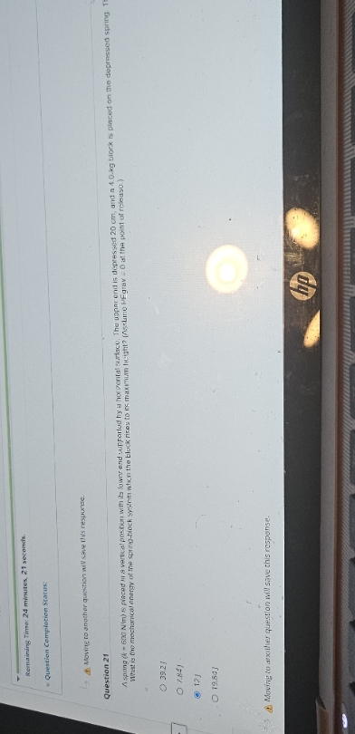 spring (k=600 N/m) is placed in a vertical position with its lower