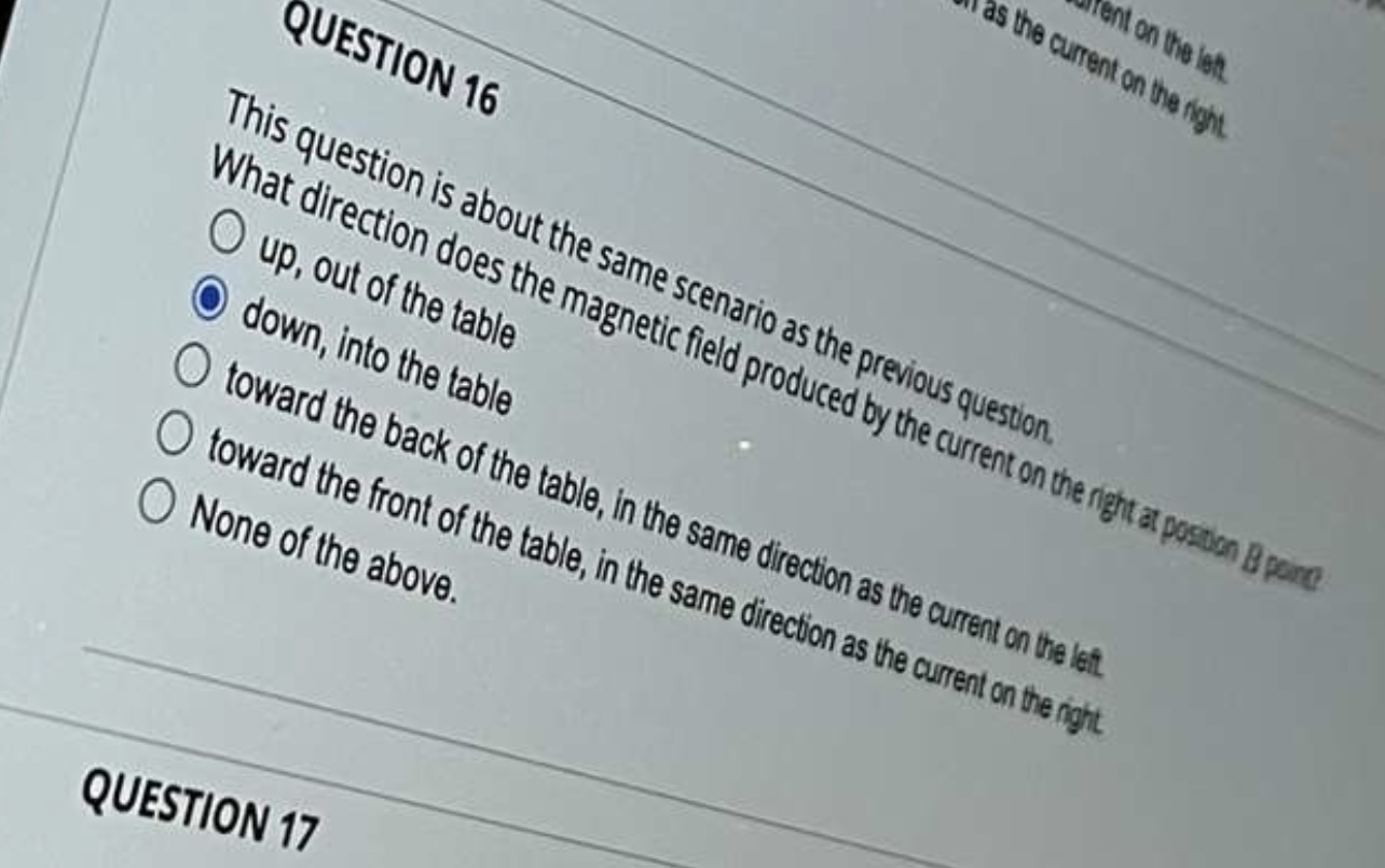 the same direction as the current on the right O None of